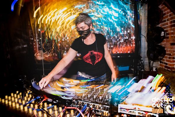 Jen Woolfe in a mask at the decks under a burst of light