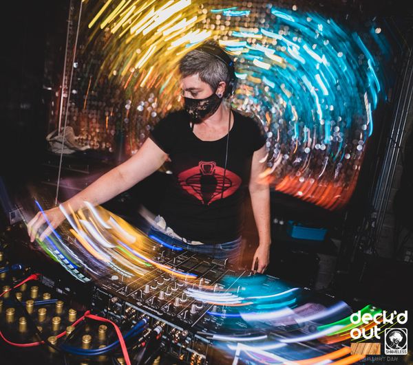 Jen Woolfe in a mask at the decks, surrounded by swirling light trails